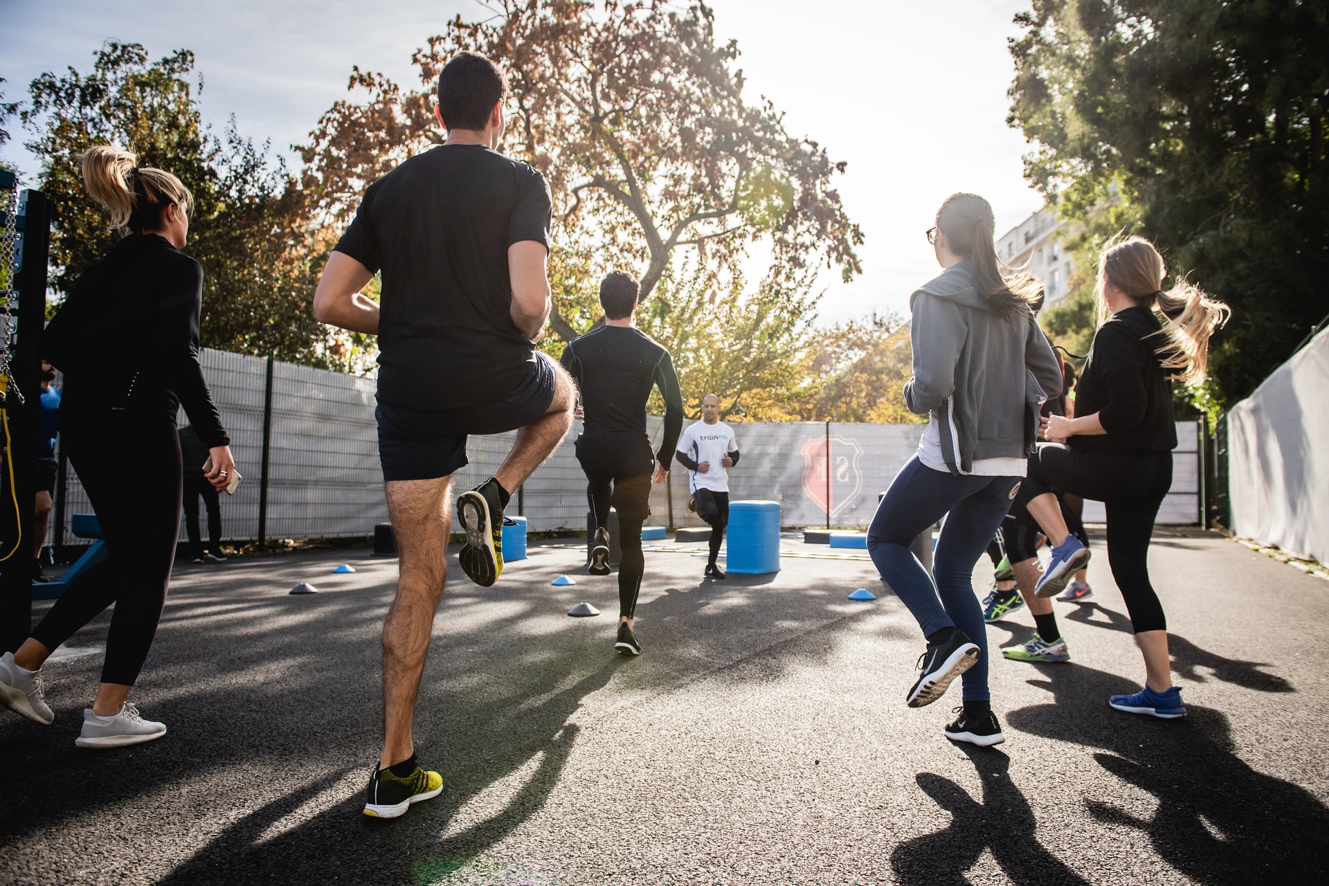 man in black t-shirt and black shorts running on road during daytime